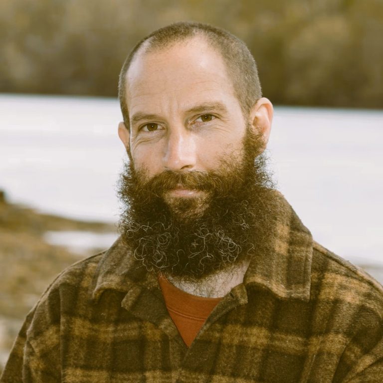 Ben Stopford, Psychotherapist North Wales, standing by a Menai Straits near Menai Bridge/Bangor.